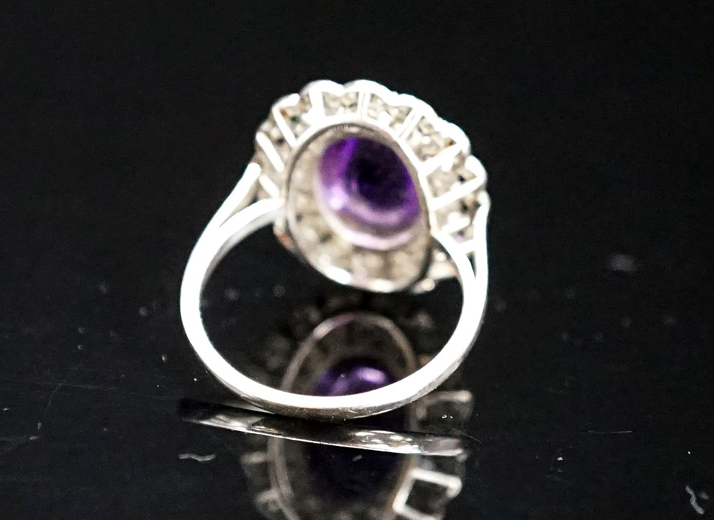 A 1920's white metal, cabochon amethyst and rose cut diamond ring, size M, gross weight 5.9 grams.